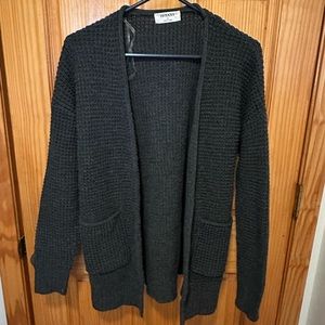 Dark gray textured cardigan sweater with functional pockets